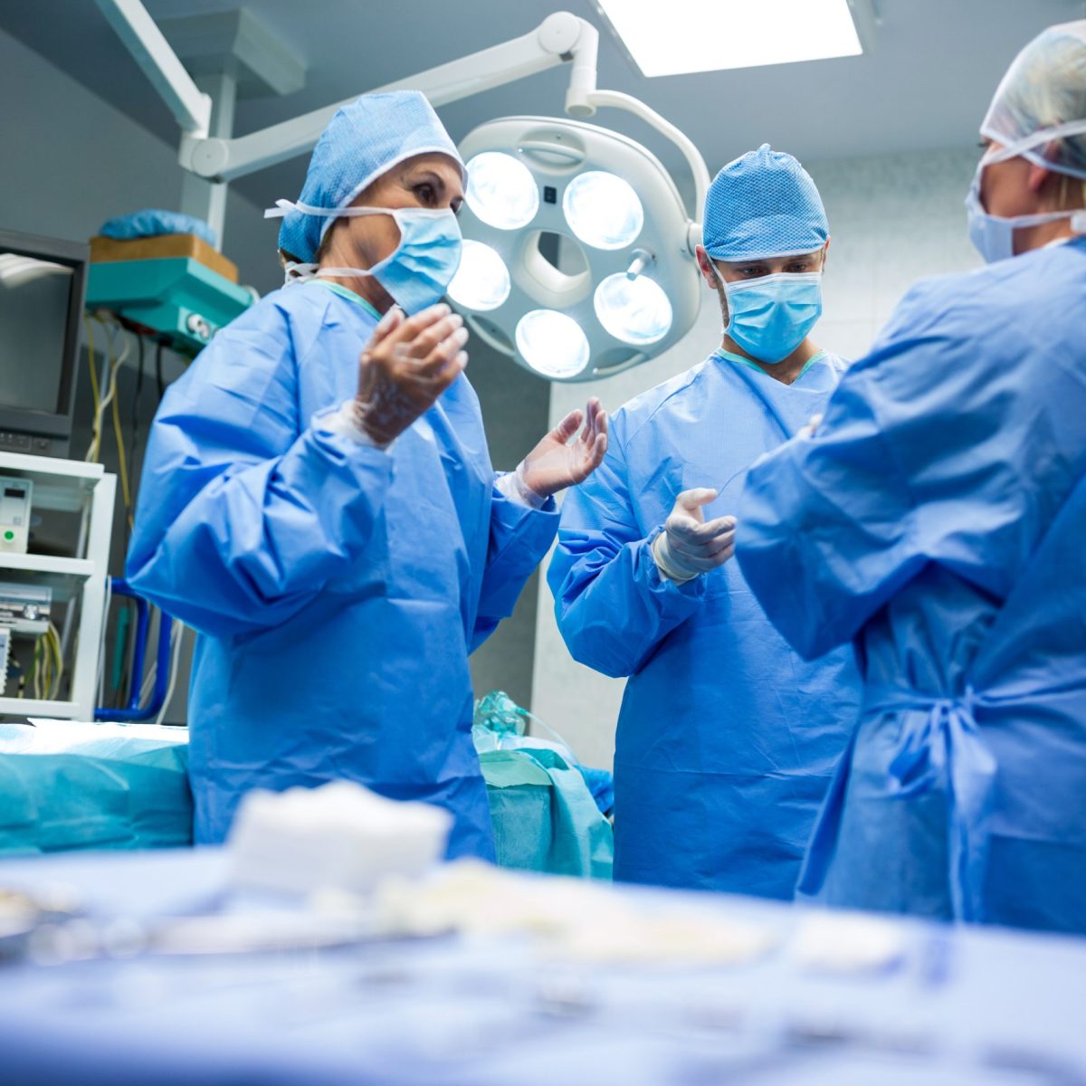 Surgeons interacting with each other in operation room at hospital